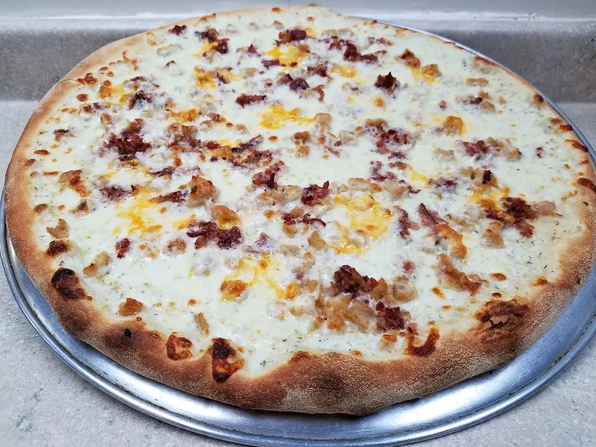A white pizza with bacon