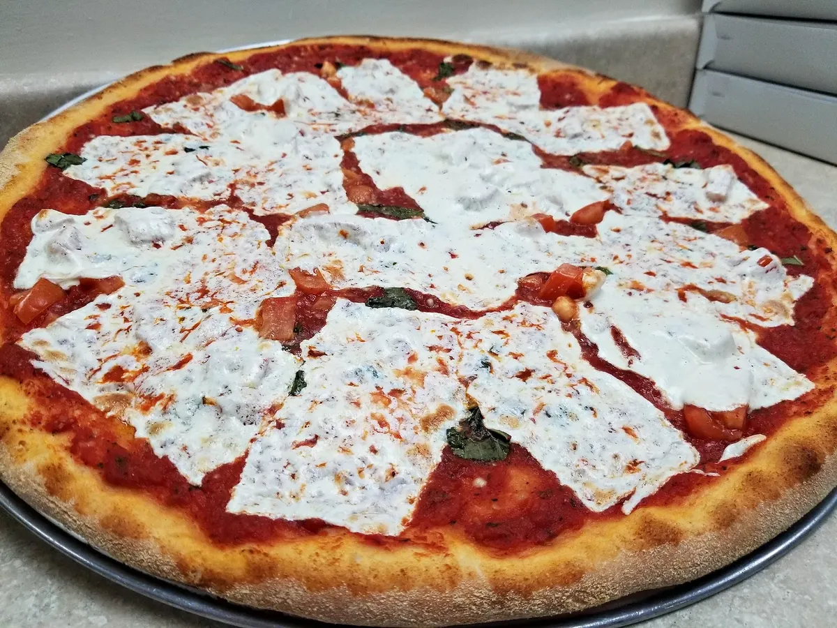 A margherita-style pizza with fresh mozzarella and basil