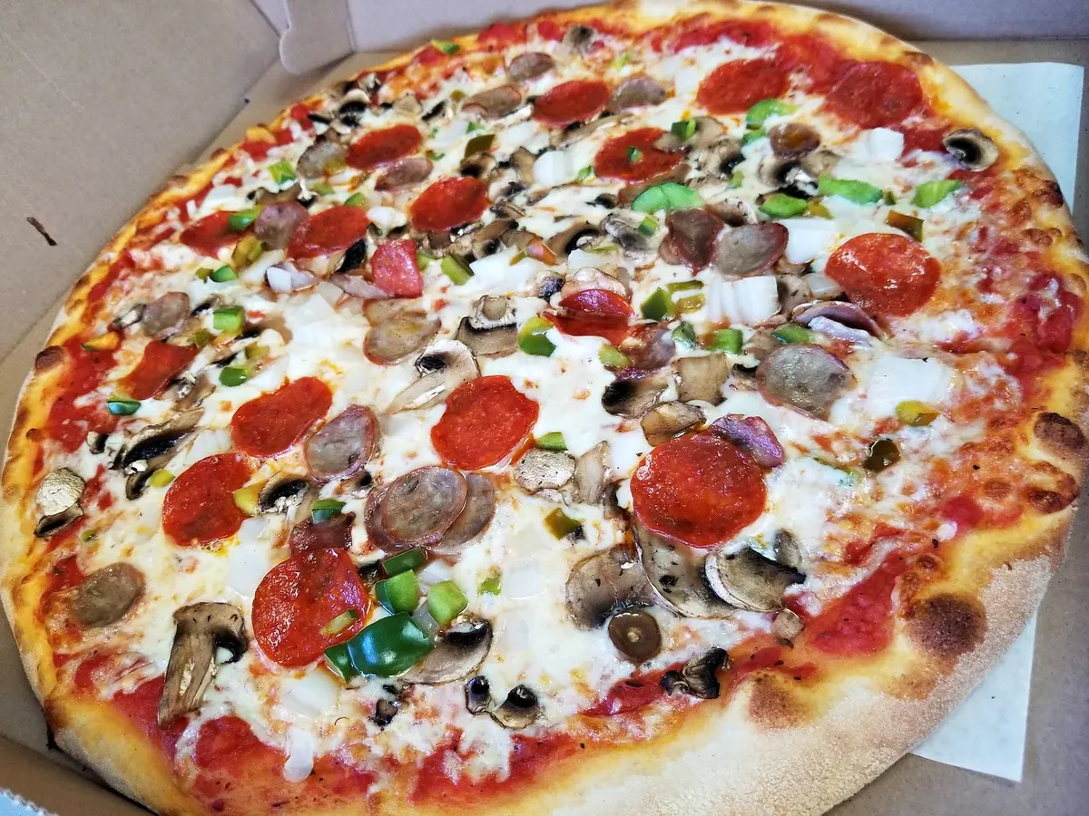 A supreme pizza with pepperoni, sausage, mushrooms, peppers and onion