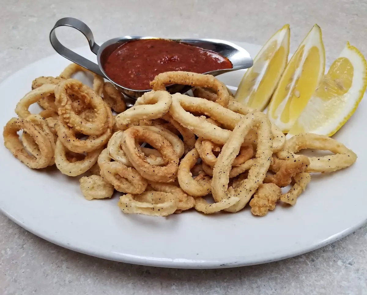 Fried calamari with marinara and a lemon wedge