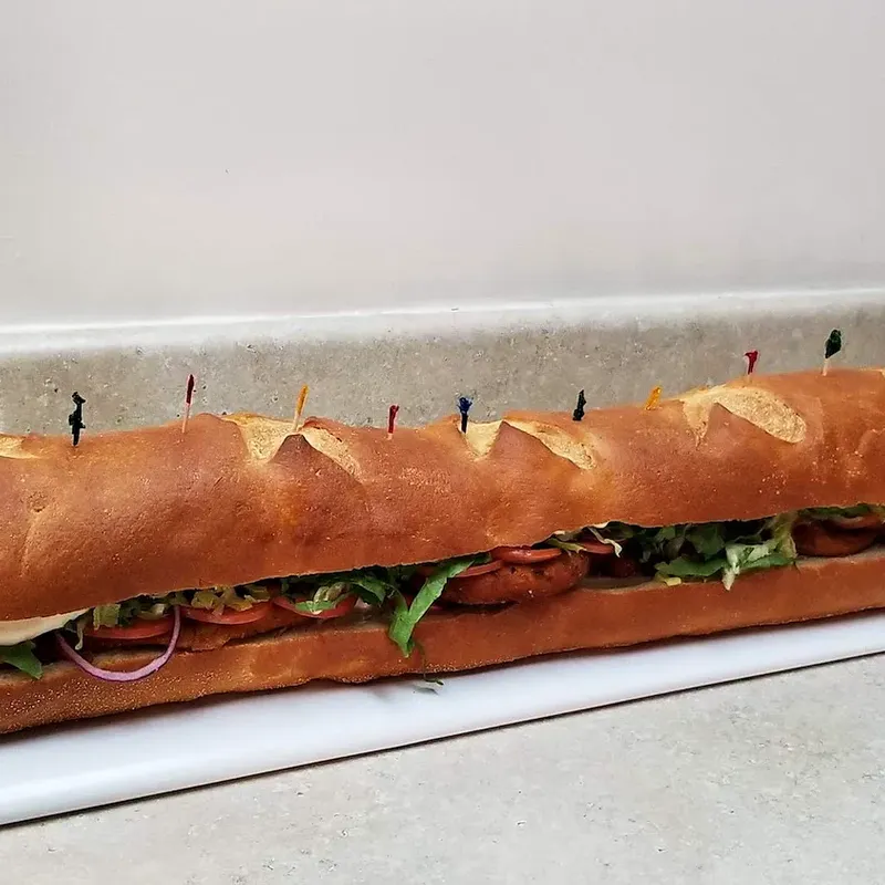 A party hero, a multi-foot sub, on the counter