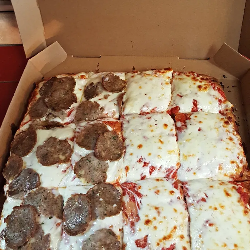 A Sicilian pie in the box, half meatball and half cheese