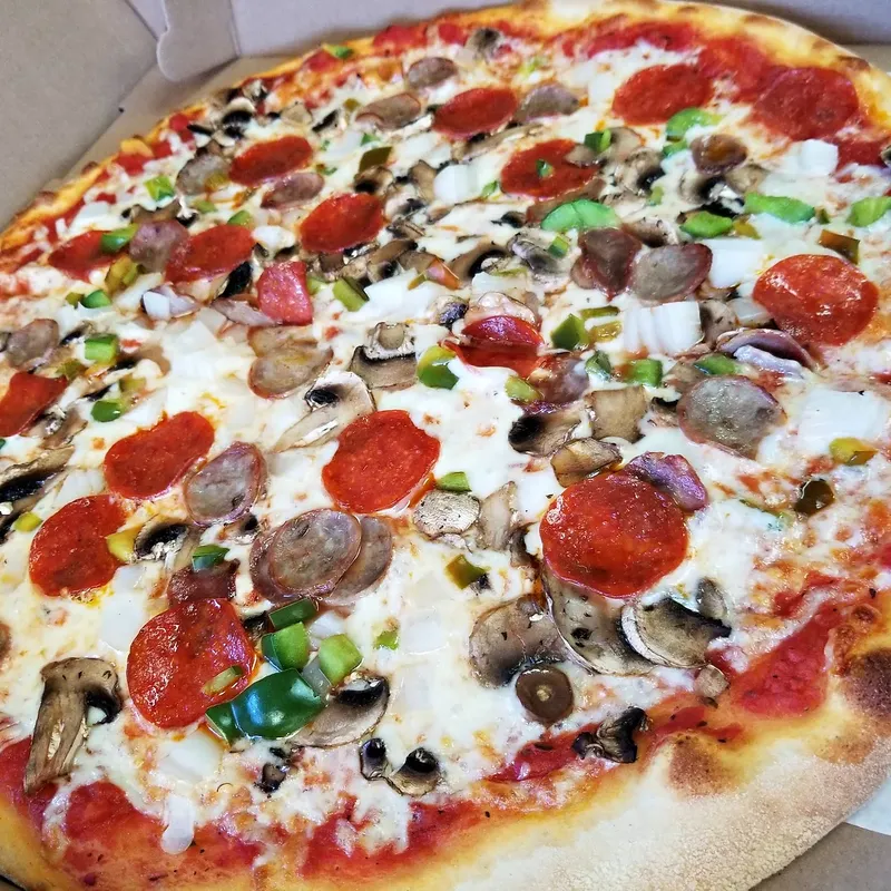 A supreme pizza with pepperoni, sausage, mushrooms, peppers and onion