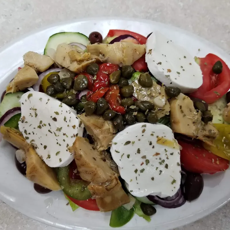 An Italiana salad with fresh mozzarella, artichokes, capers and roasted peppers