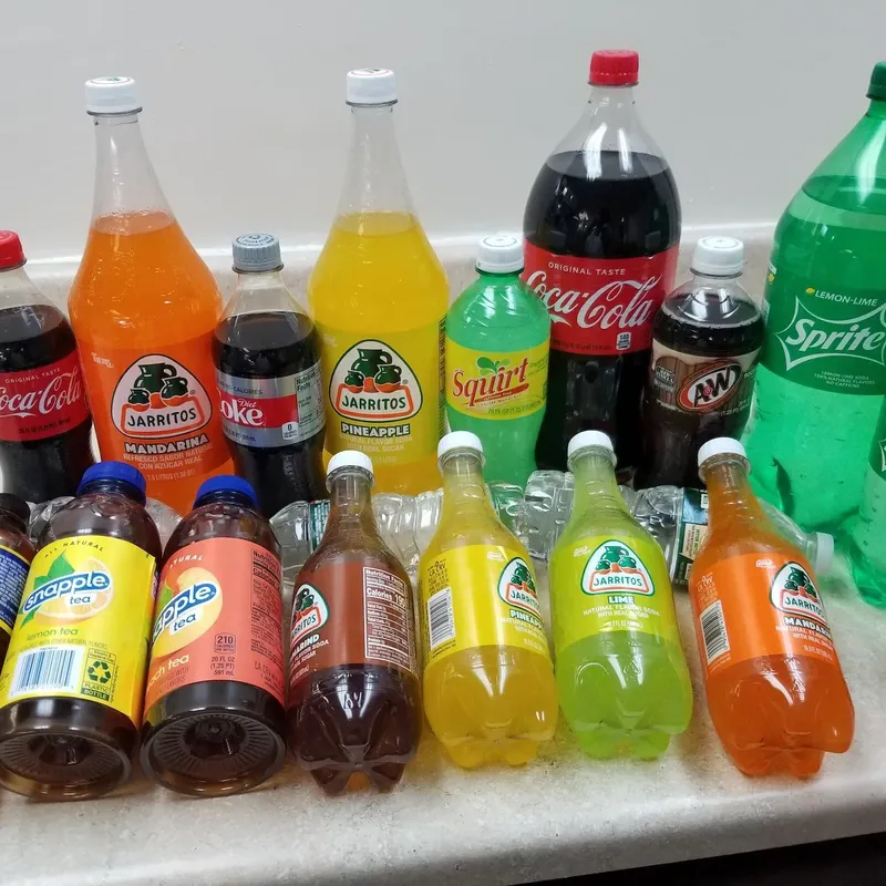 A line-up of sodas: Coke, Sprite, Jarritos and Snapple